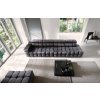 Rovná sedacia súprava DRACO SOFA V9 tmavosivá v modernom interiéri, pohľad zhora na dlhú pohovku s výrazným prešívaním a veľkým presklením.